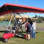 Brian baker showing the first group around John's Microlight (Trike)